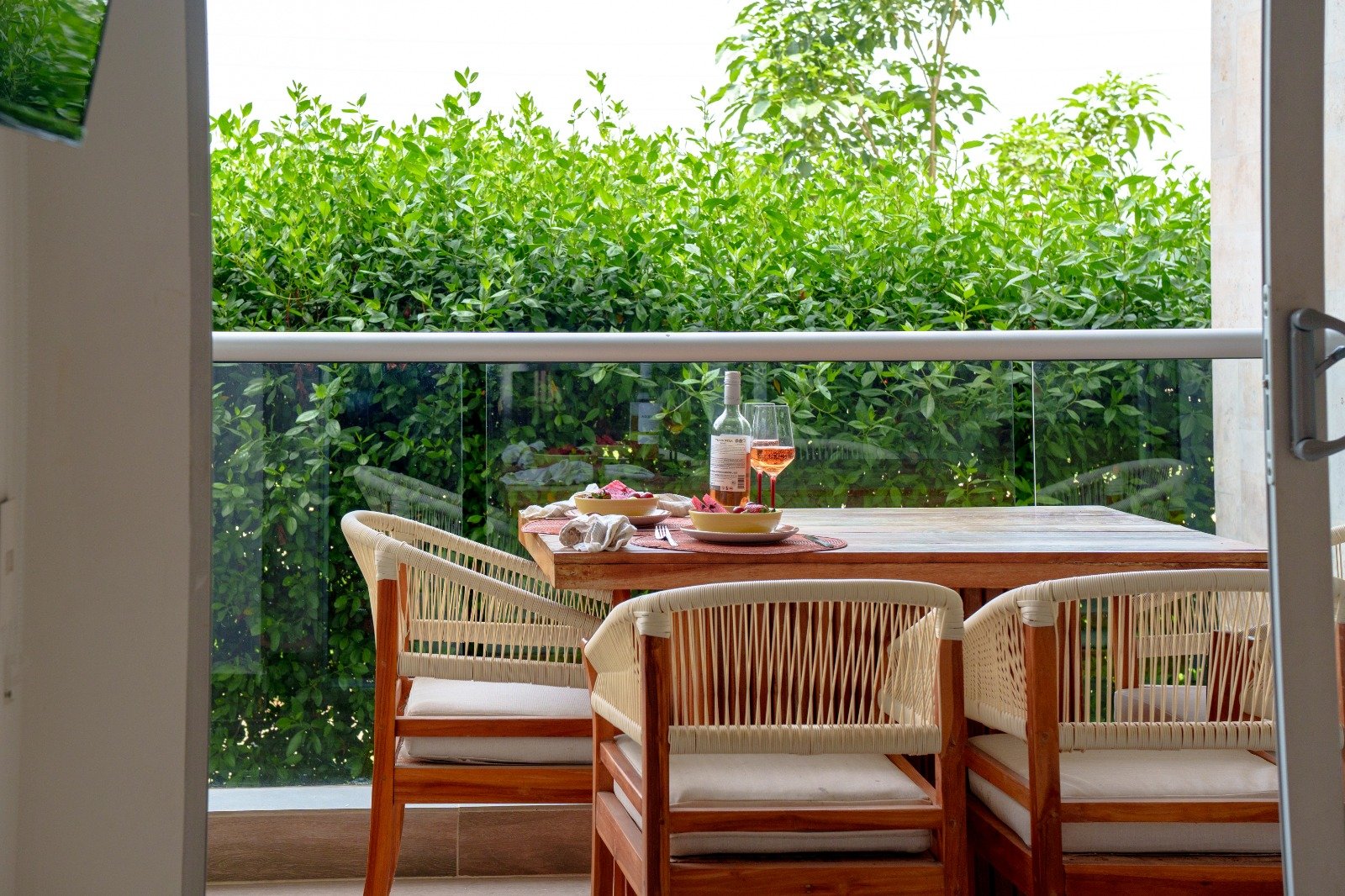 Quiet balcony with a table and tropical greenery