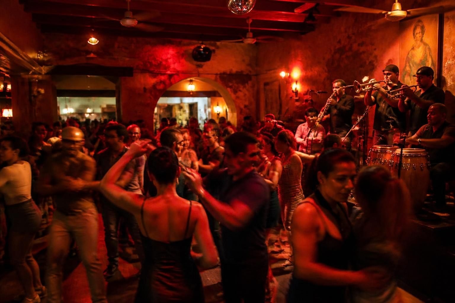 Couples dancing salsa to a live band